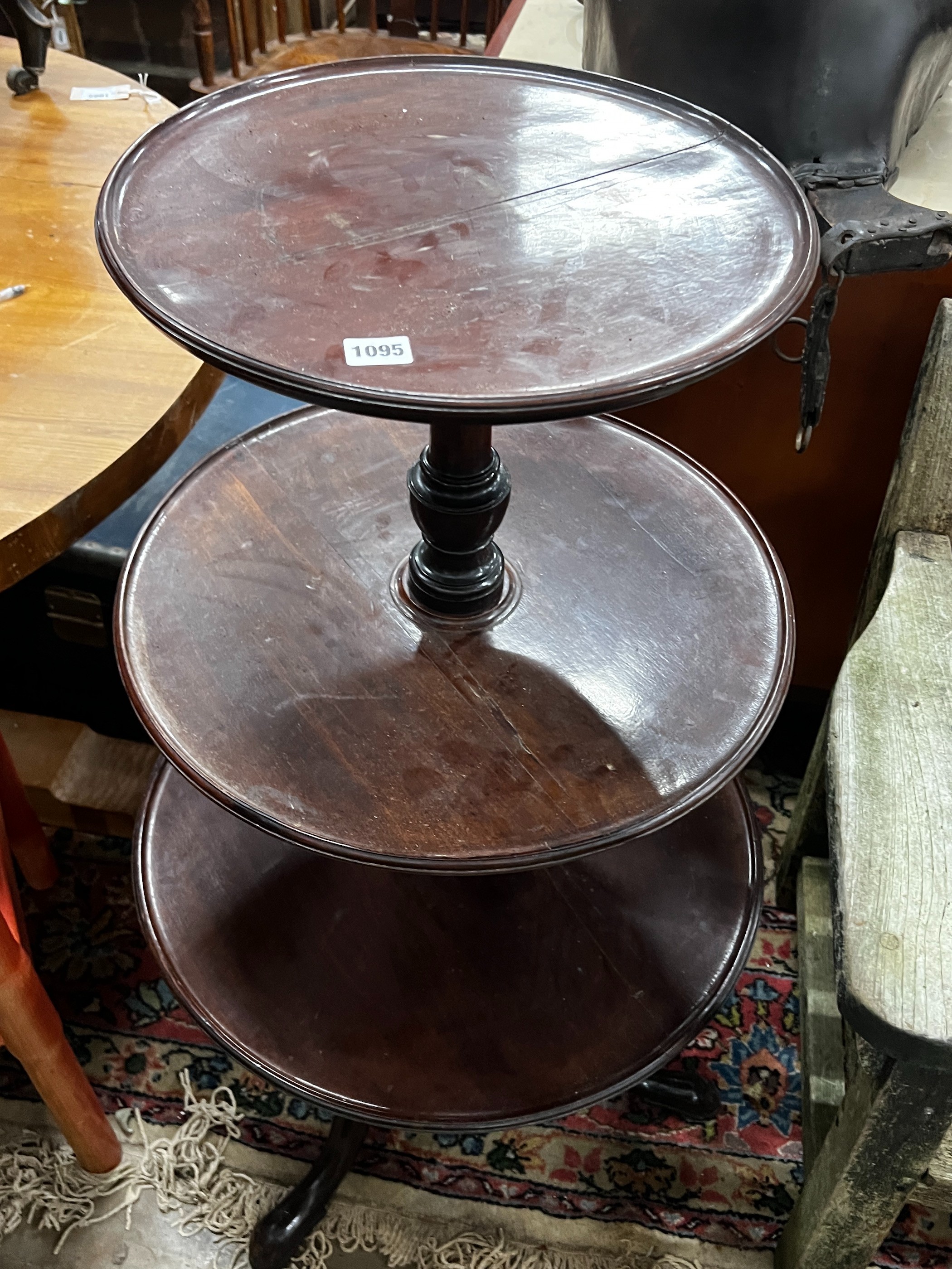 A George III and later circular mahogany three tier dumb waiter, height 108cm